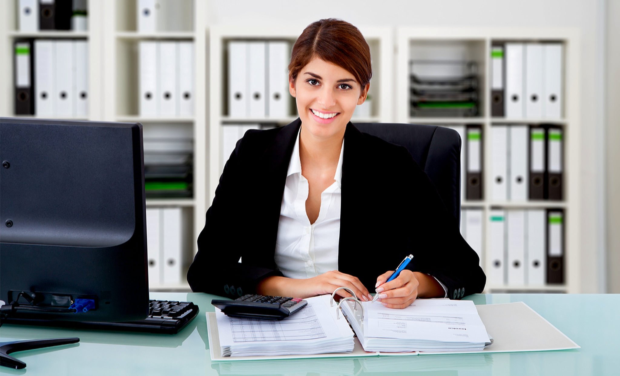 an accountant woman smiling and working on her office